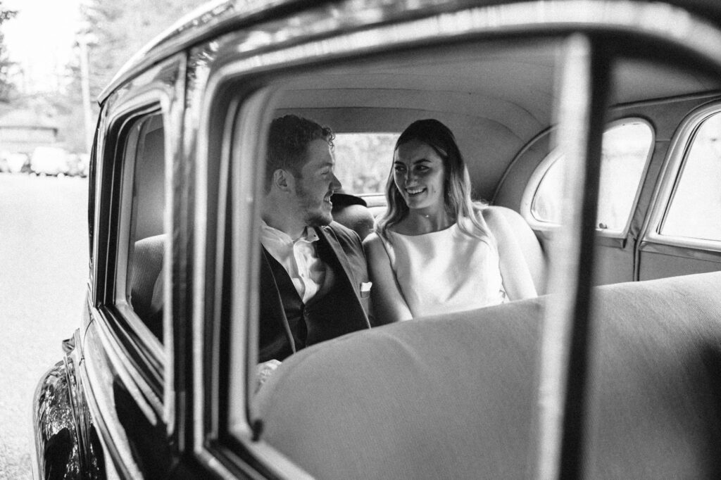 A wedding couple in a getaway car