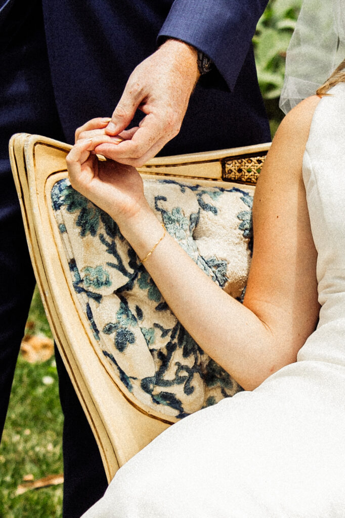 a close up of a couple's hands on wedding day