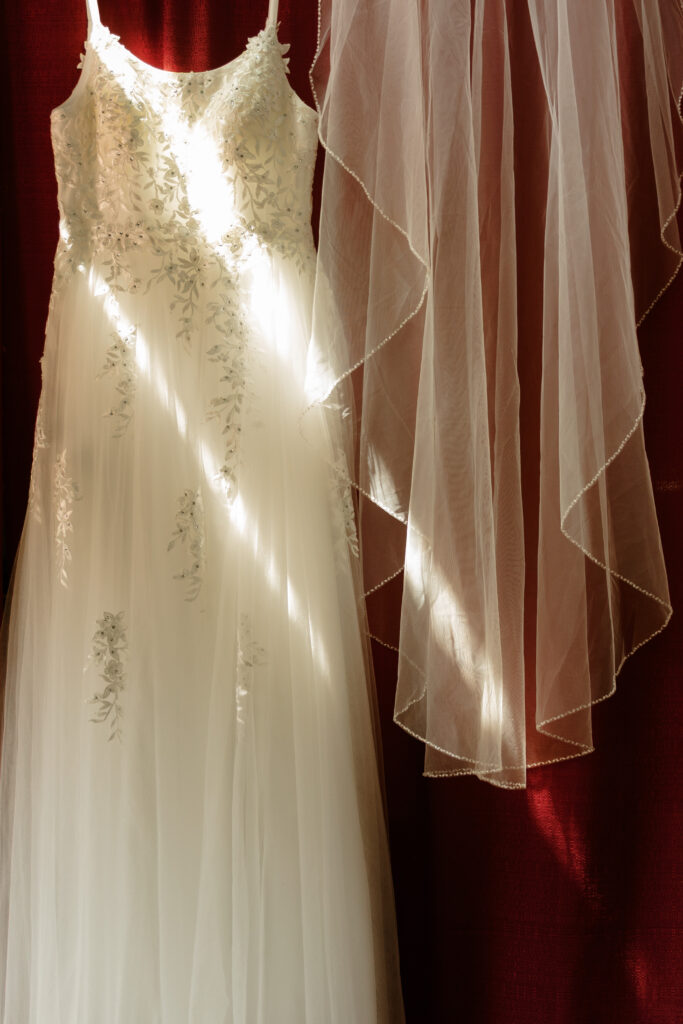 Close-up of Rachel’s vintage-style wedding dress and breezy veil with fairycore touches