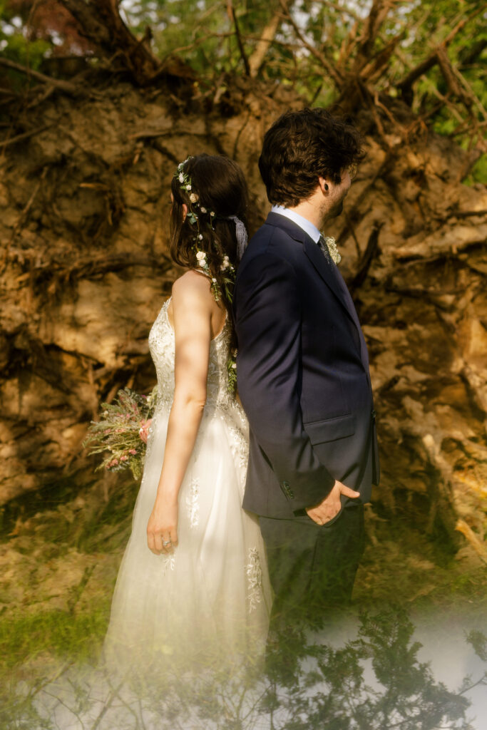 Romantic wedding portrait of the couple near a fallen tree after the summer storm at Bella Tori