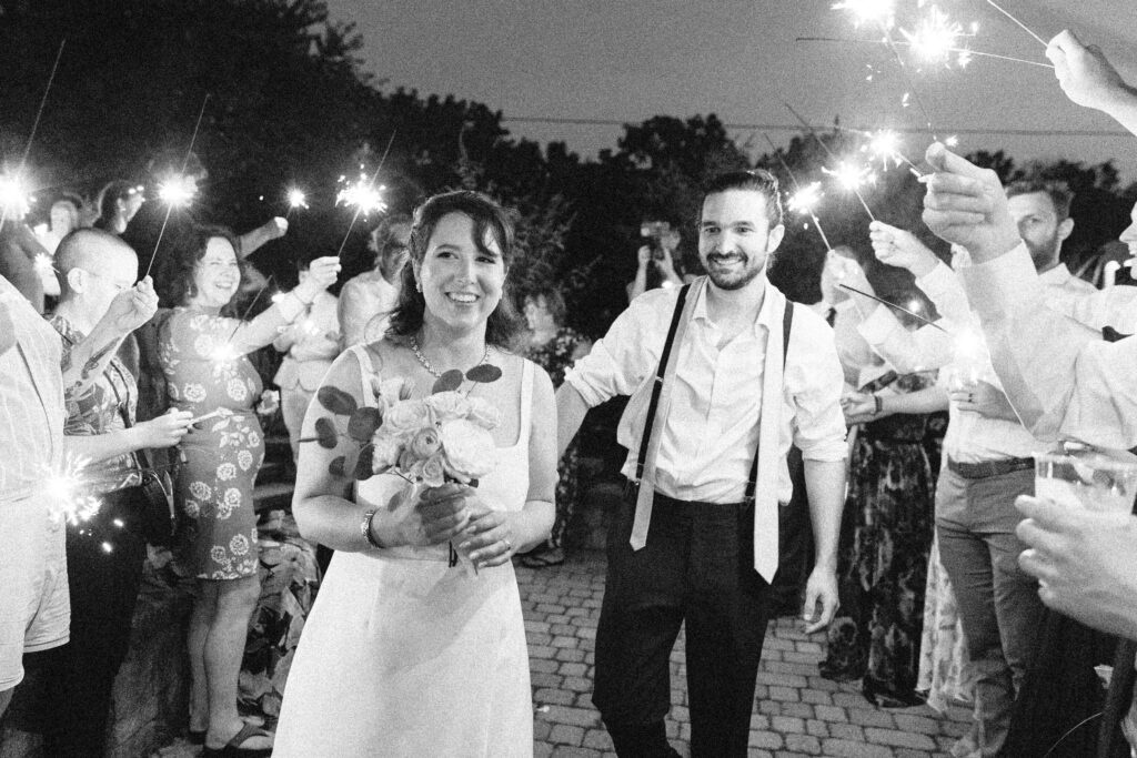 Black and white photo of sparkler exit with cinematic vibes