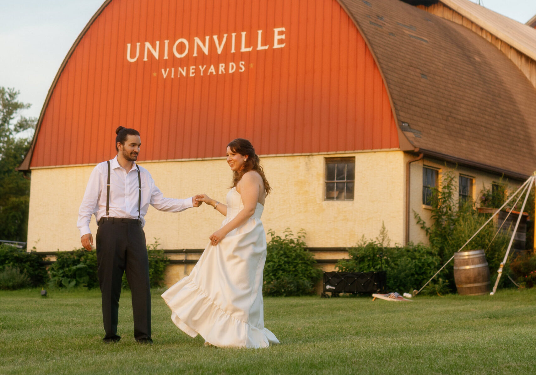 Bride and groom in front of rustic barn at Unionville Vineyards