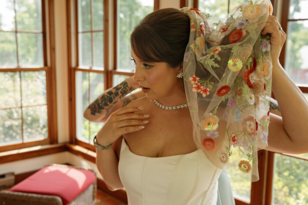 Bride and maid of honor during getting ready moments in farmhouse