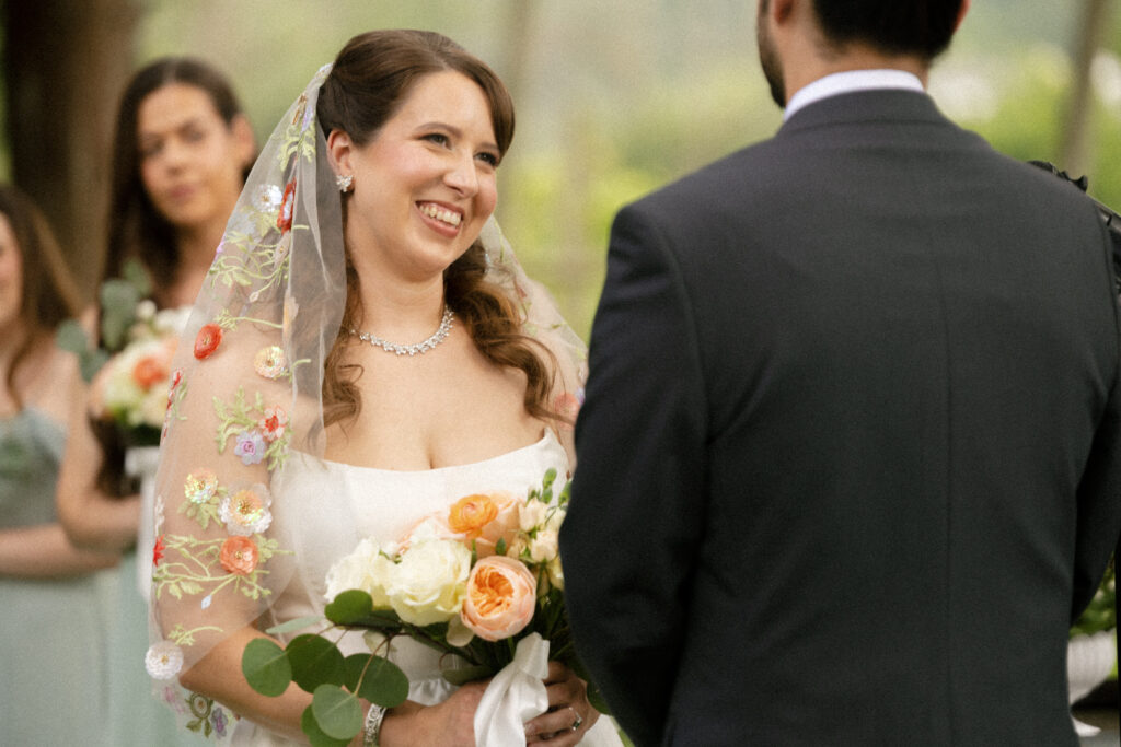 Bride reading vows during intimate vineyard ceremony