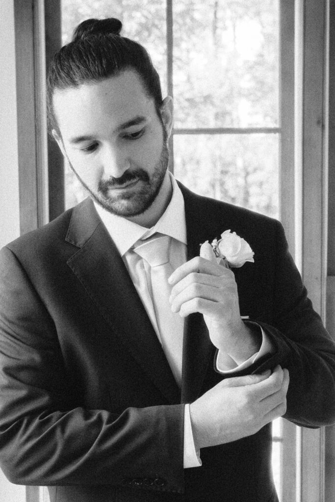 Groom portrait after first look in natural light-filled sunroom