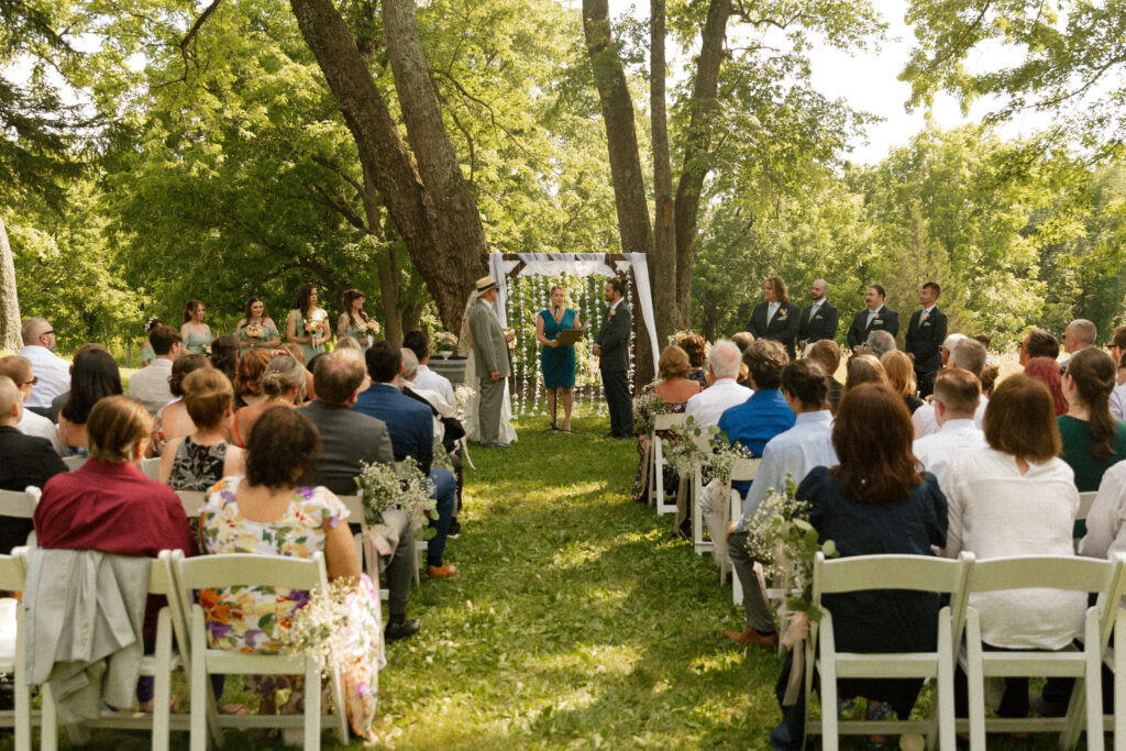 Outdoor wedding ceremony with vineyard backdrop at Unionville