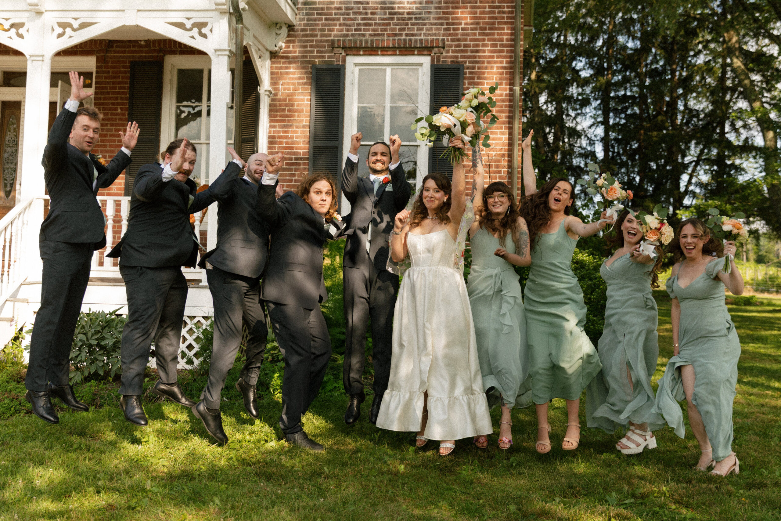 Wedding party jumping for joy at a Philadelphia wedding, with kids respectfully edited out to protect their privacy — captured by documentary and cinematic wedding photographer Studio Starling